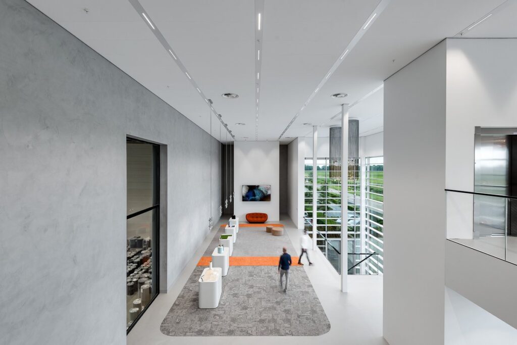 Interior view of the showroom with white presentation tables and panoramic views.