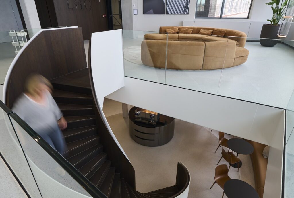 Slender staircase connecting office levels.