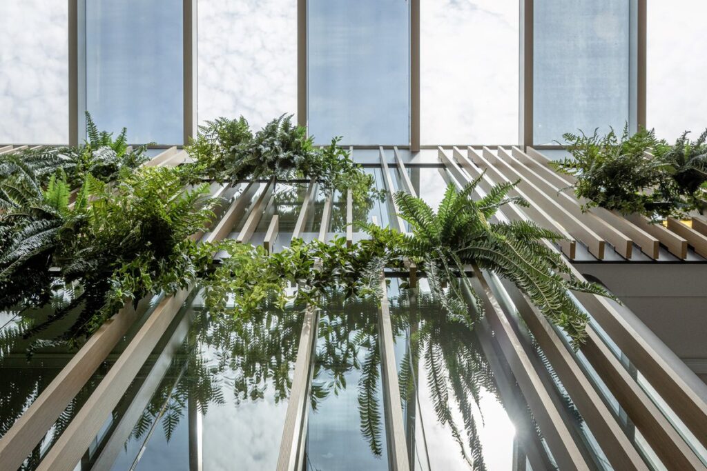 High wooden slatted wall with greenery