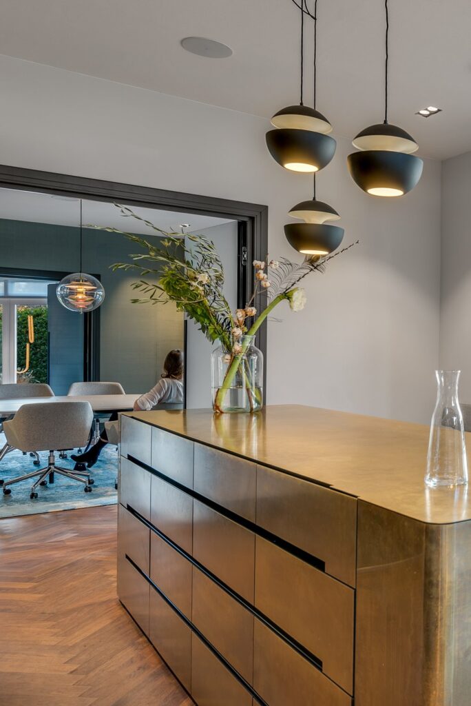Interior view of the office villa with a brass kitchen island