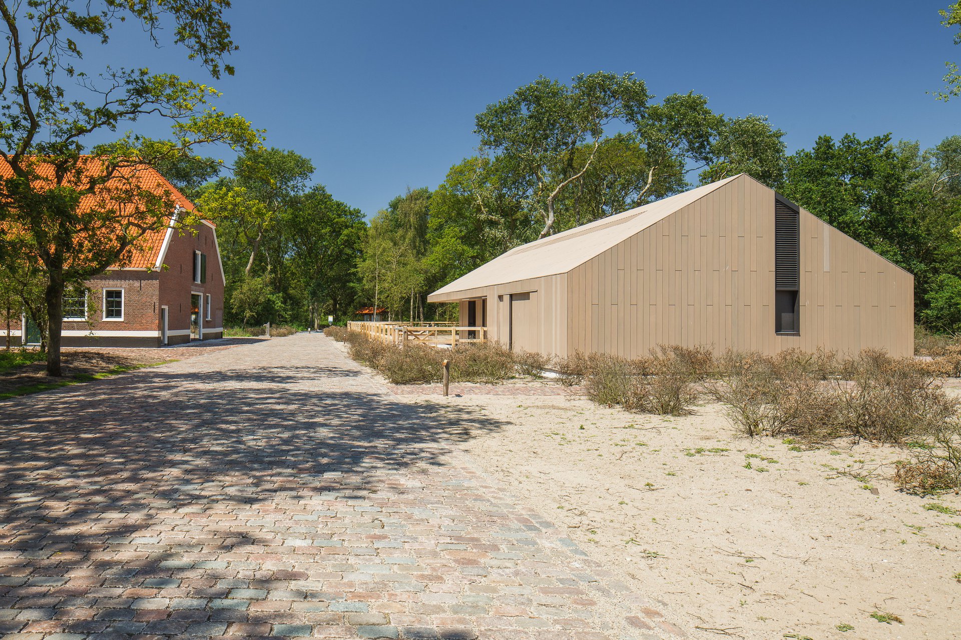 Historic barn in decay converts to visitor center as part of the transformation of a farm ensemble