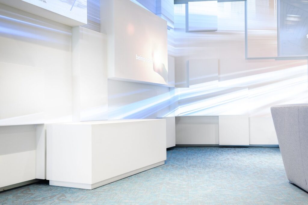 Curved glass walls structure the space, elegantly merging product display areas with a laboratory.