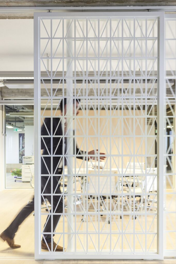 Interior view of the office with glass doors and concrete structure.