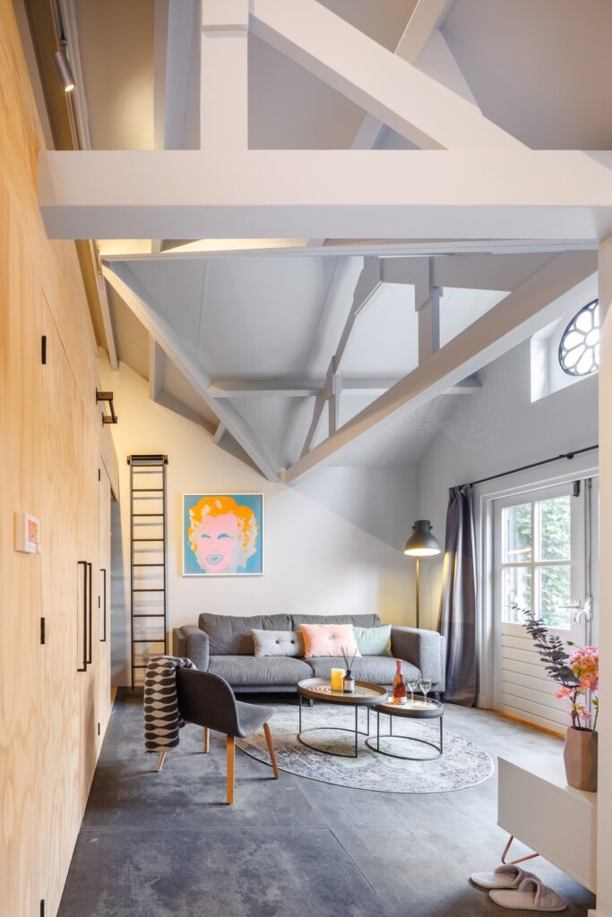 Interior view of the tiny house with wooden volume and exposed rafters